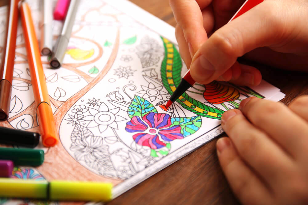Coloring in coloring book using colored pens