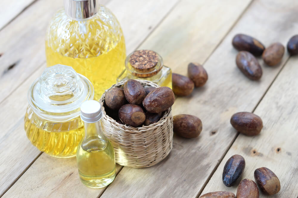 Nutmeg oil surrounded by loose nutmeg