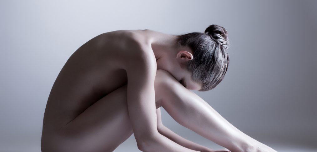Nude model reflecting on body image