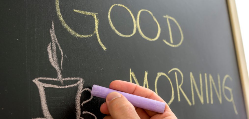 Writing "Good Morning" on chalkboard