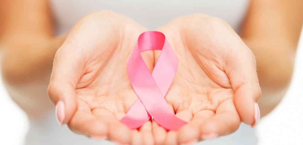 Woman holding a breast cancer ribbon