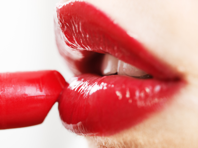 Applying red lipstick