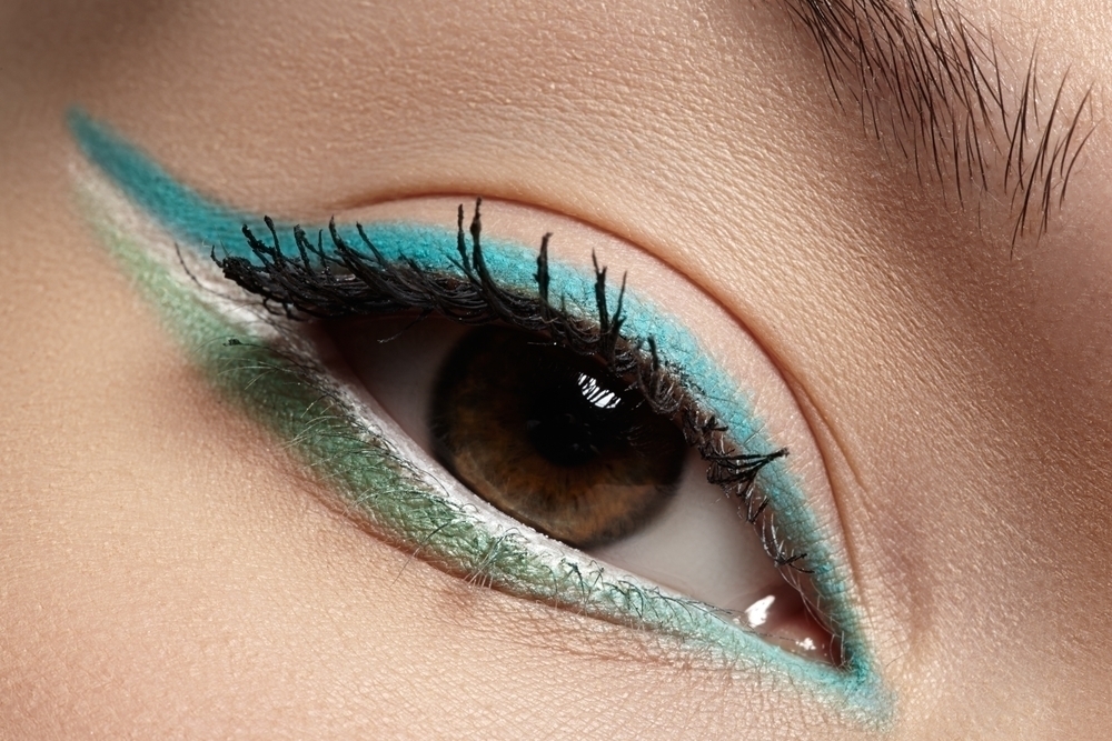 Woman with mint makeup on her eyes. 