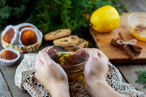 Woman's hands holding cup of green tea