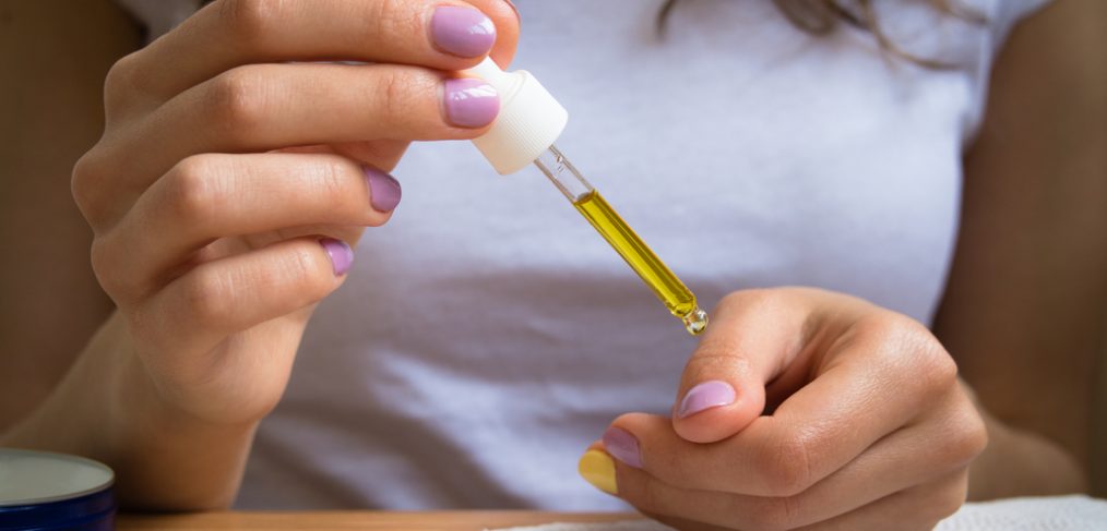 Woman applying nail oil