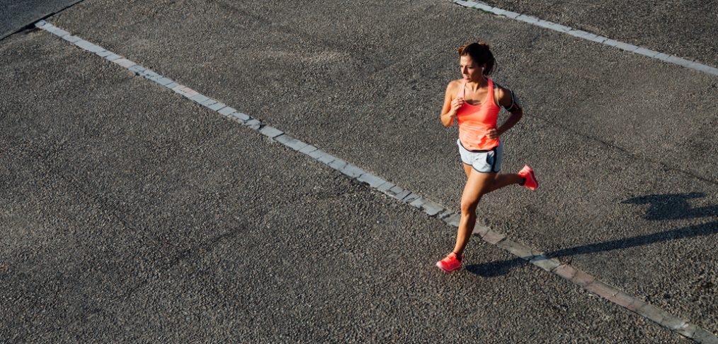 Woman running across track