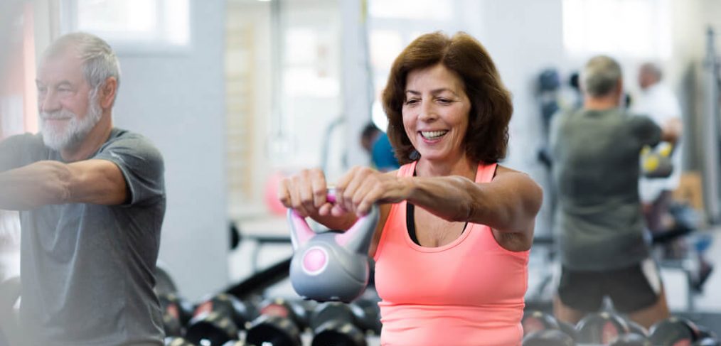 Woman exercising with kettlebell in gym