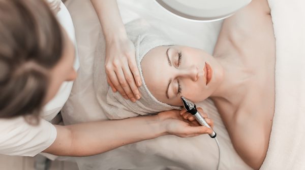 Woman undergoing facial spa treatment